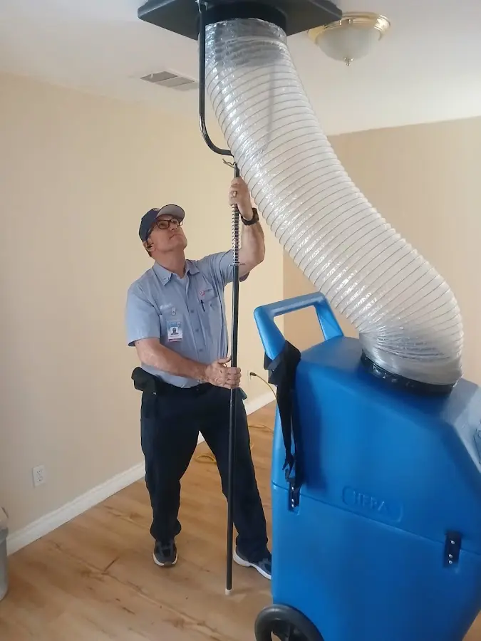Furnace Tune-Up technician using HEPA equipment in Denton